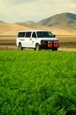CalVans vehicle driving through farmland