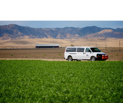 CalVans vehicle driving through farmland